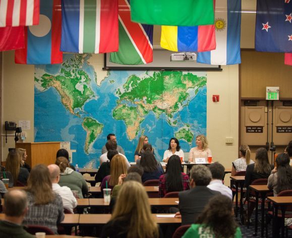 students sitting in class with flags above them