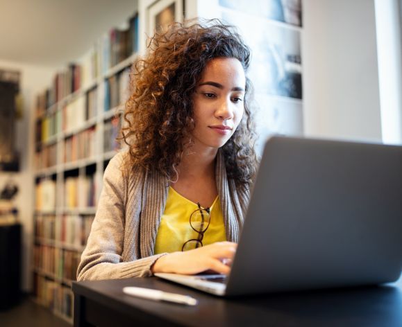 Student on a laptop researching.