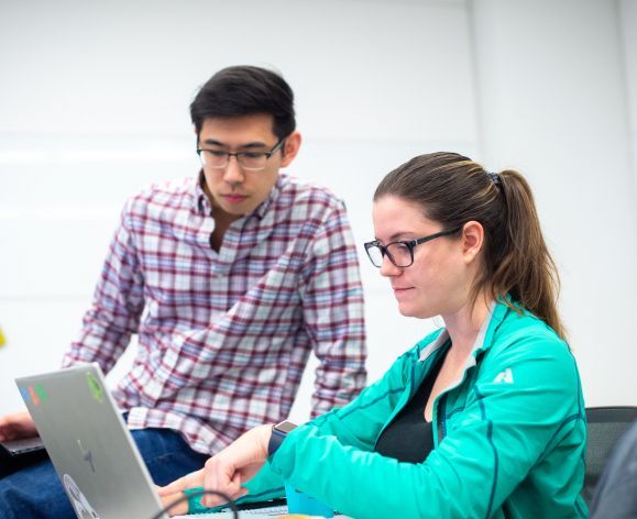 students looking at laptop