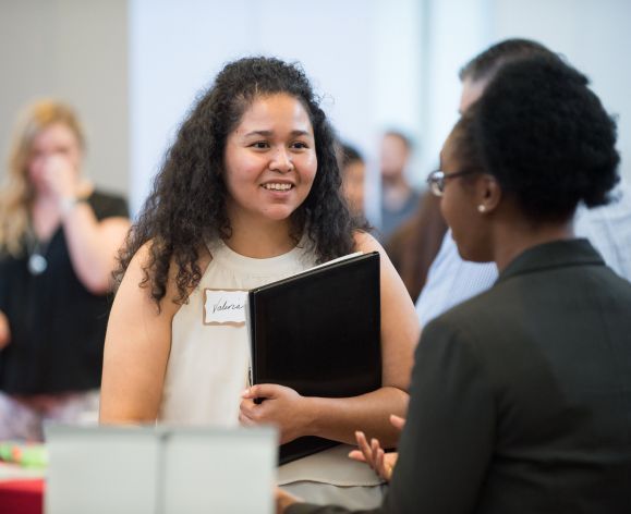 Student speaking with employer at Meet the Firms day