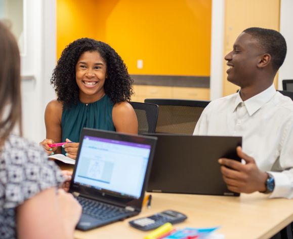 students sitting together smiling at each other