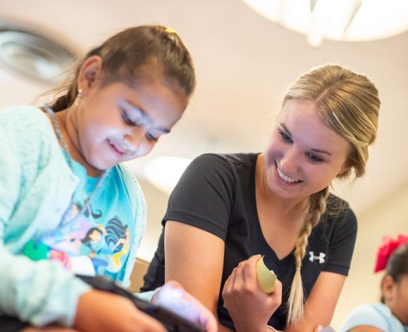 student working with child