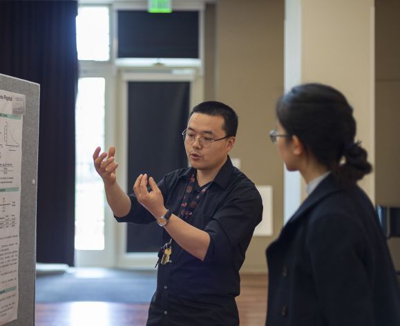 Student presenting a research poster