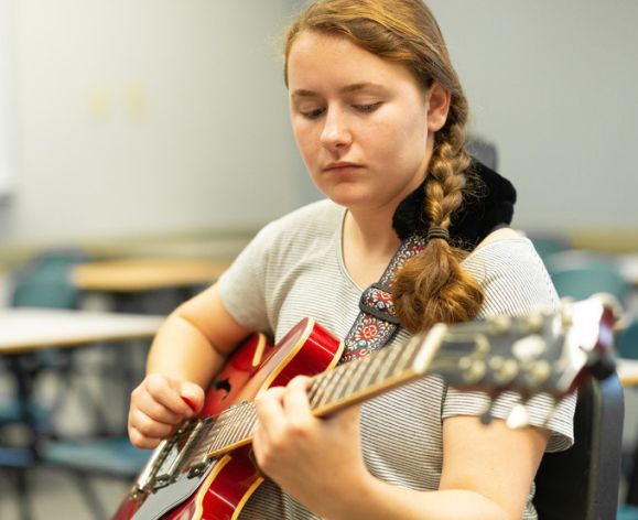 student playing a jazz guitar