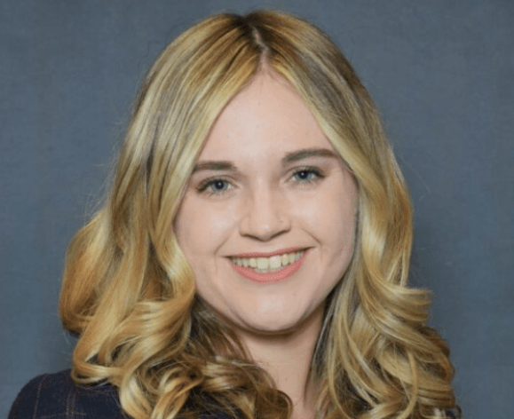 A portrait of a woman wearing a suit