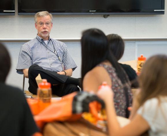 Professor John Livesy in classroom with undergraduate students