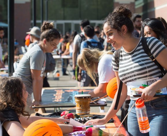 Undergraduate students at a club fair in front of the DeRosa University Center