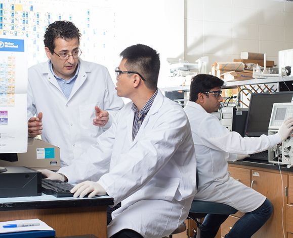 Faculty and students having a discussion in the lab