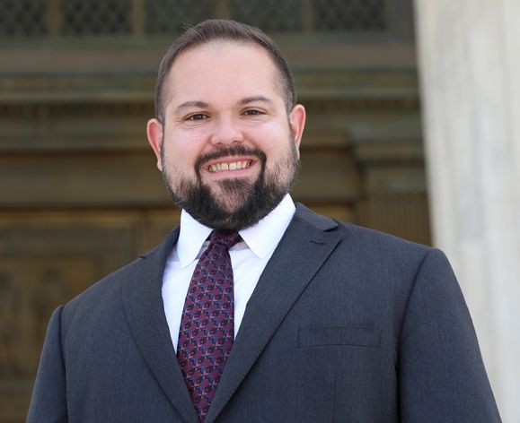 A portrait of a man wearing a suit