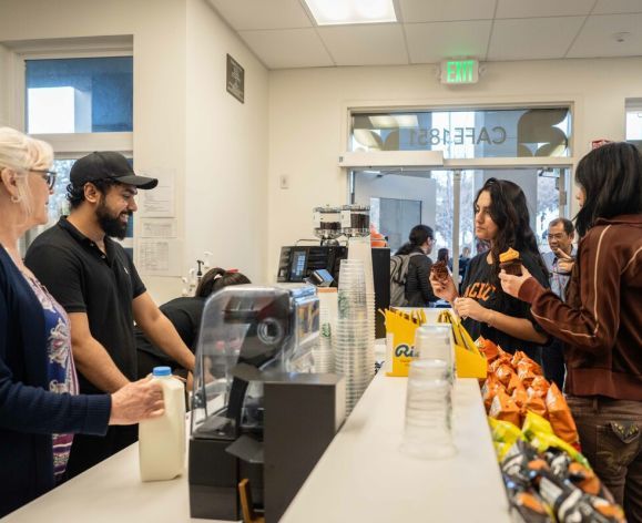 Students making a purchase at the counter in Cafe 1851.