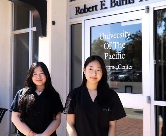 two pre-health students in front of burns tower