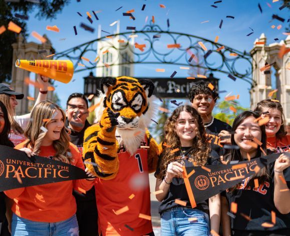 students cheering in front of the gate