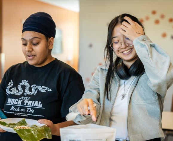 Two female students cooking together.