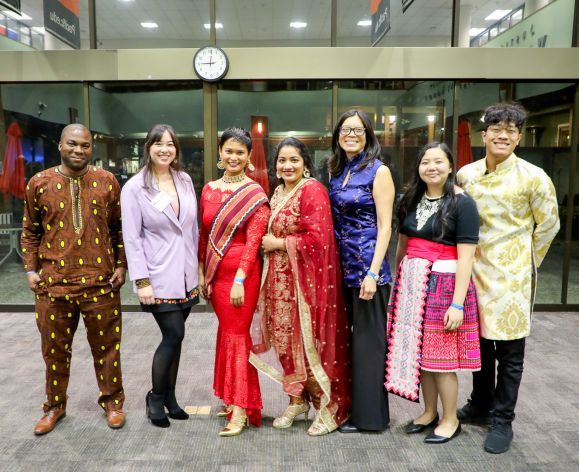 a group of individuals wearing traditional attire posing for a photo