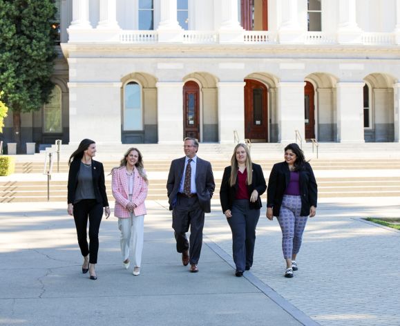 students and professor walking in front of the Capitol