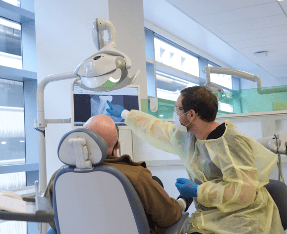 patient and dental student in clinic